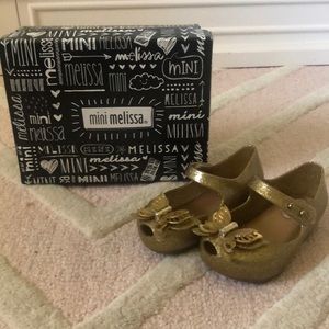 Great gold mini Melissa shoes for a little girl